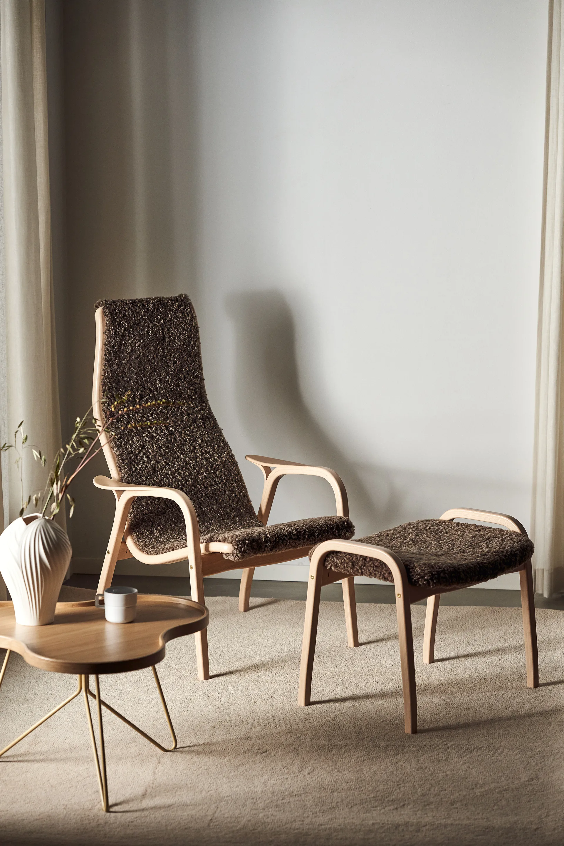 Lamino armchair and footstool varnished beech/sheepskin, Sahara (nougat-brown) Swedese
