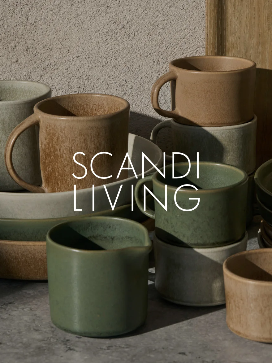 Collection of earthy-toned ceramic mugs and dishes, some stacked, with 'SCANDI LIVING' text overlay.