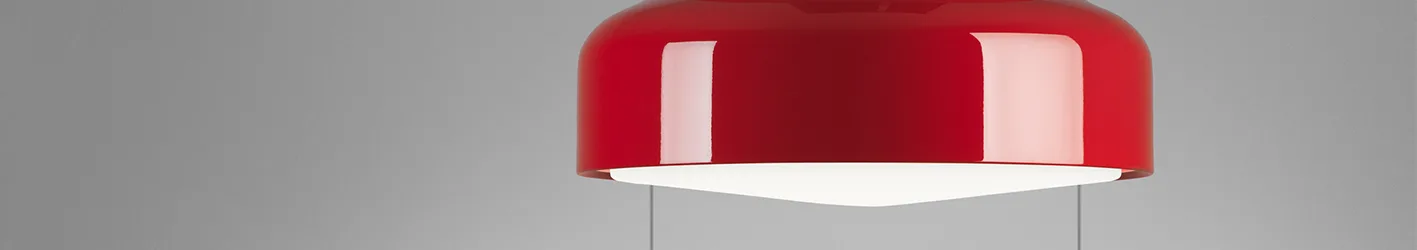 Glossy red pendant light with a white diffuser, suspended against a gray background.